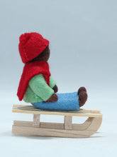 Kid Doll on Sleigh – 2.5" Handmade Felt Waldorf Doll by Ambrosius